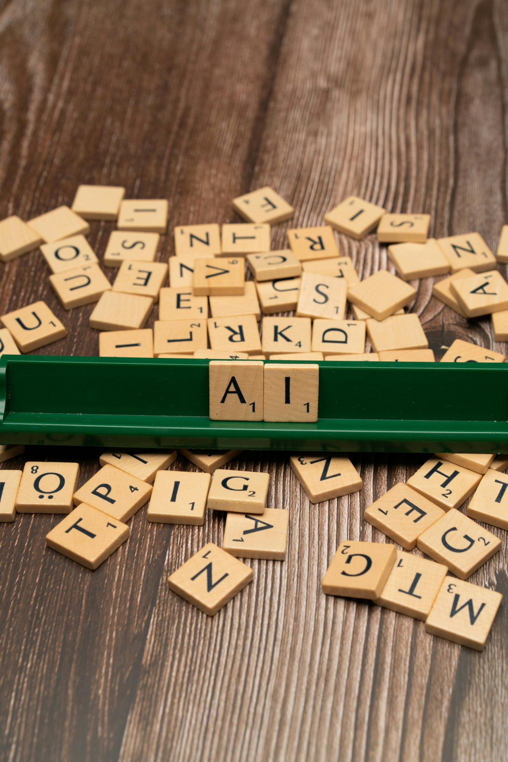 Scrabble pieces spelling out AI.